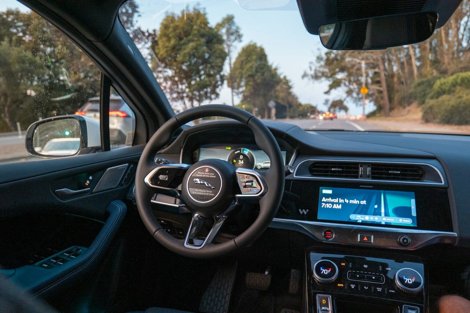 Inside a car, looking out at a road.