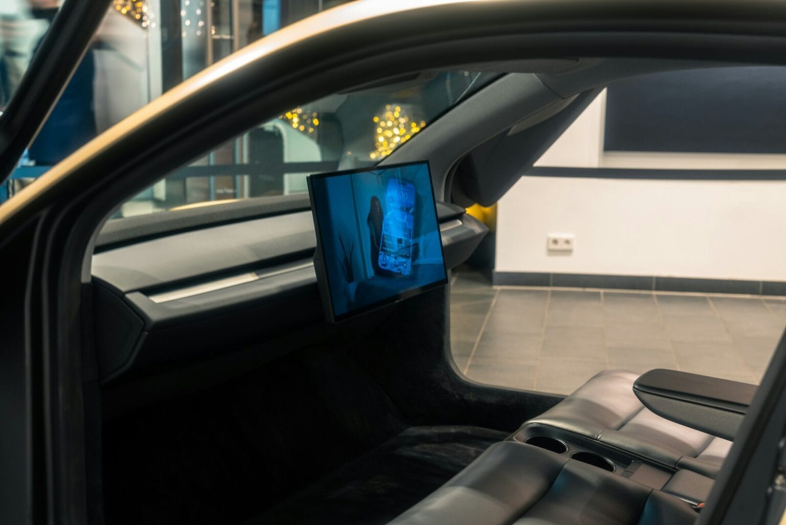 A picture of a man's face on a monitor in a car