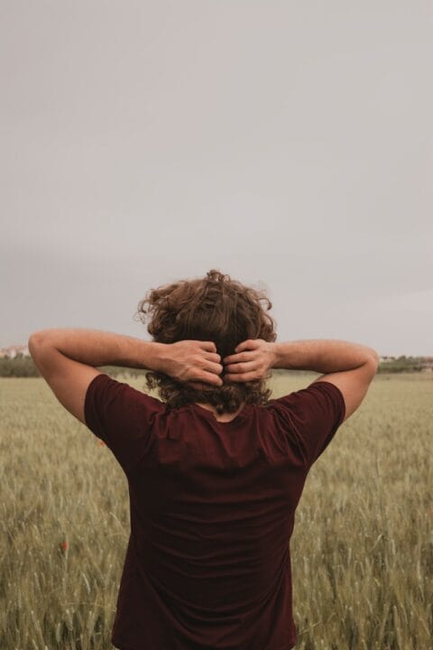 woman in red shirt holding brown hair